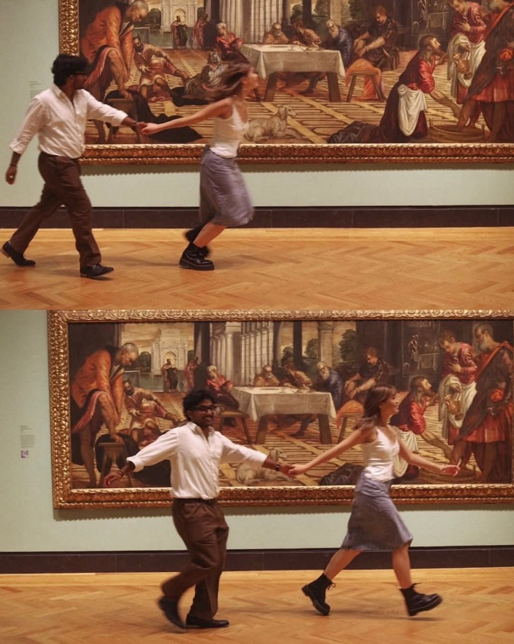 Two people dancing joyfully in a museum gallery in front of large classical paintings on display.