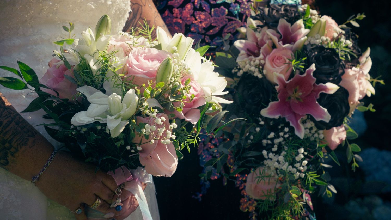 Close-up of elegant wedding bouquets featuring pink roses, white lilies, and baby's breath with green foliage.