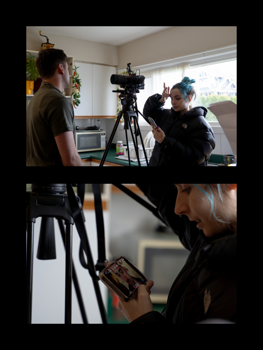 Female filmmaker with teal hair operating a camera on tripod while directing a male actor indoors.