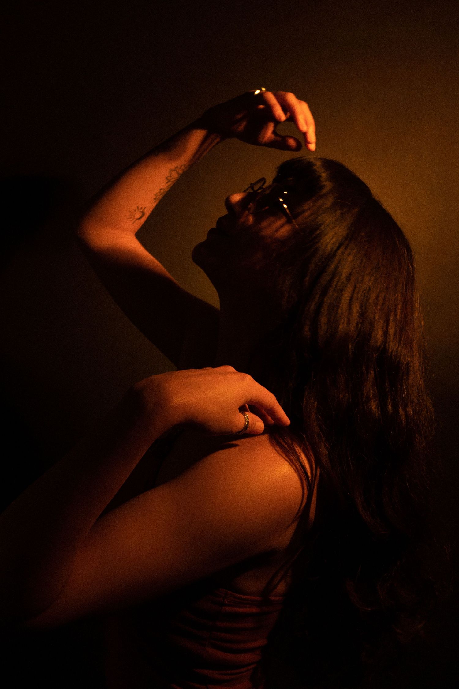 Artistic low-light portrait series with dramatic shadows and movement.