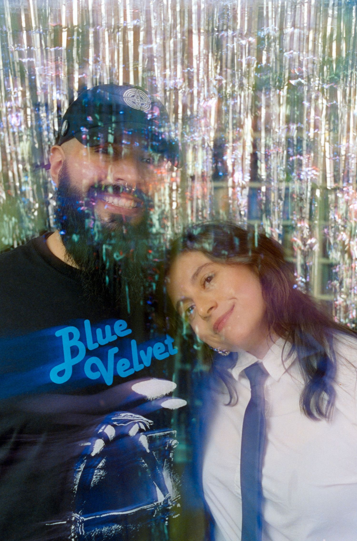Multiple exposure photos with tinsel backdrop and blue neon signage.