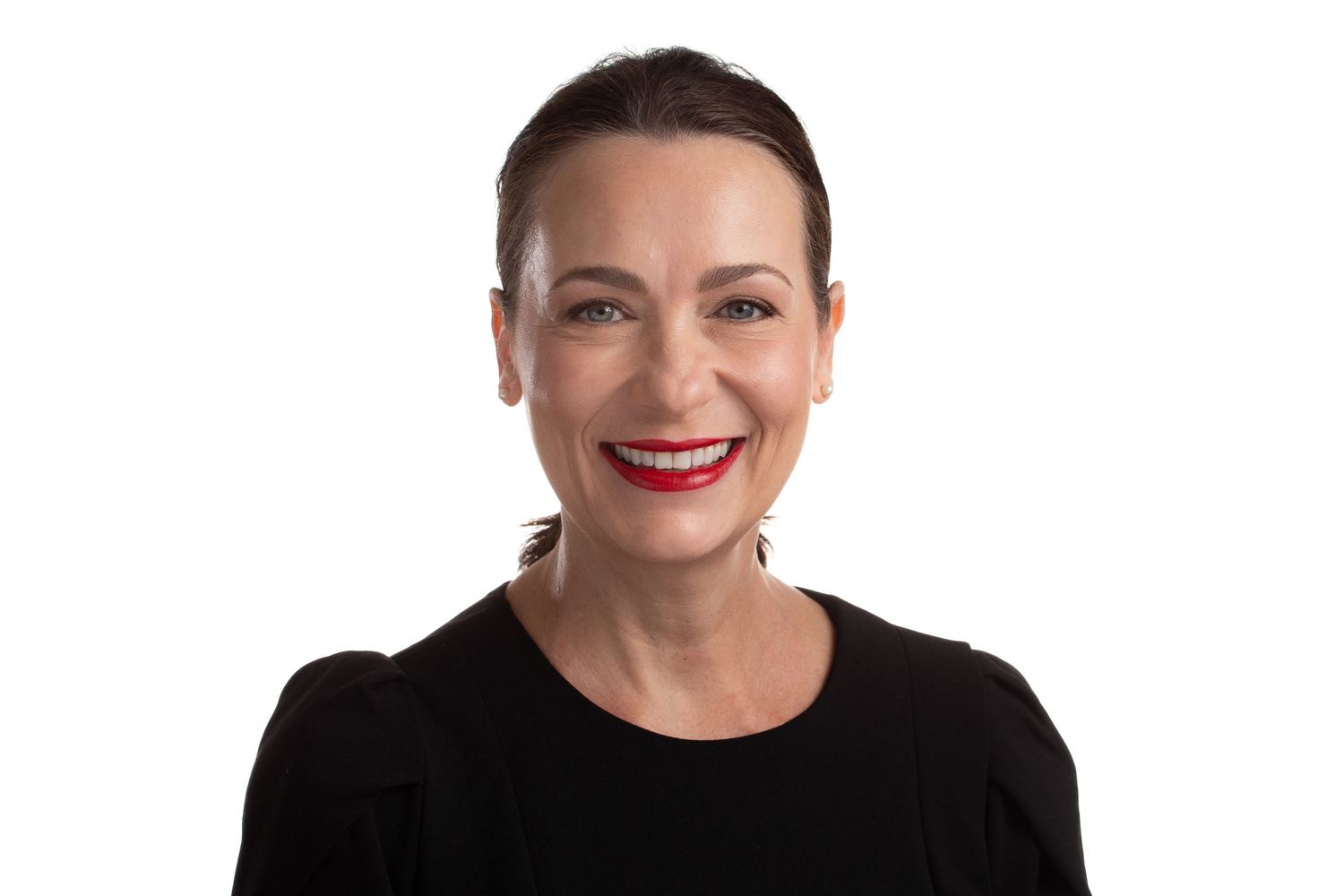 Professional studio portrait against white background.
