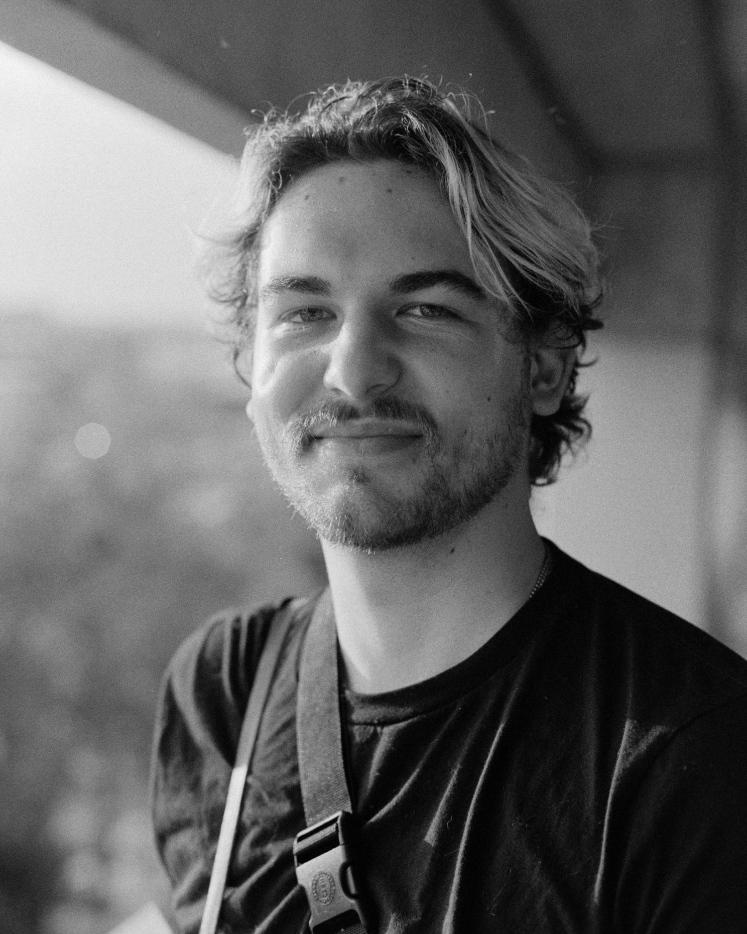 Series of black and white portraits showing casual expressions and smiles.