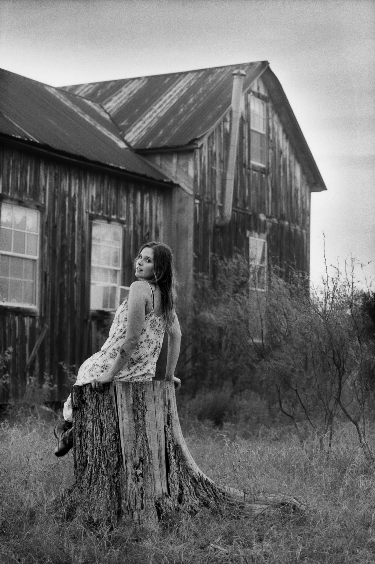 Artistic black and white photos with rustic wooden buildings in the background.
