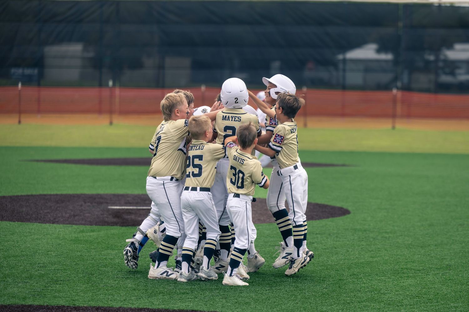 Little league baseball players celebrating a win
