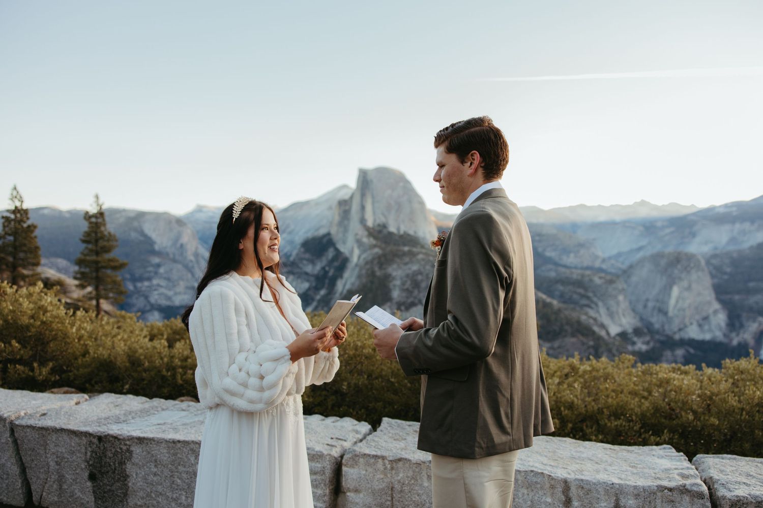 Couple exchanging vows at Yosemite's Glacier Point with Half Dome mountain views during an outdoor elopement ceremony.