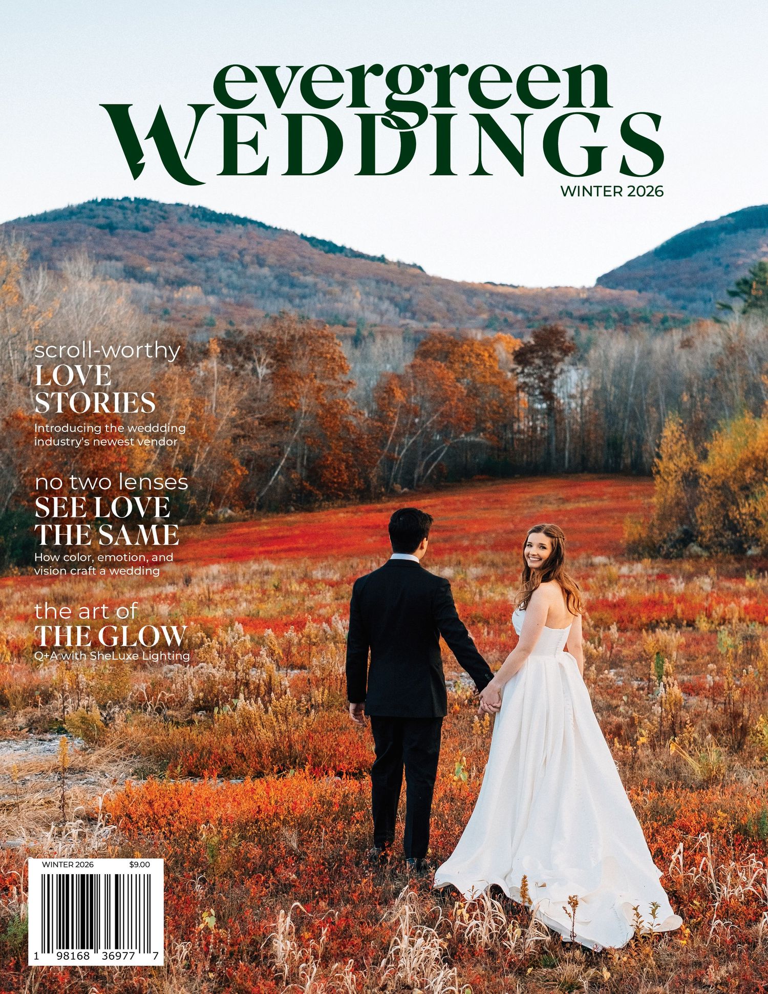 Wedding couple stands in vibrant autumn landscape with red and orange foliage for magazine cover photoshoot.