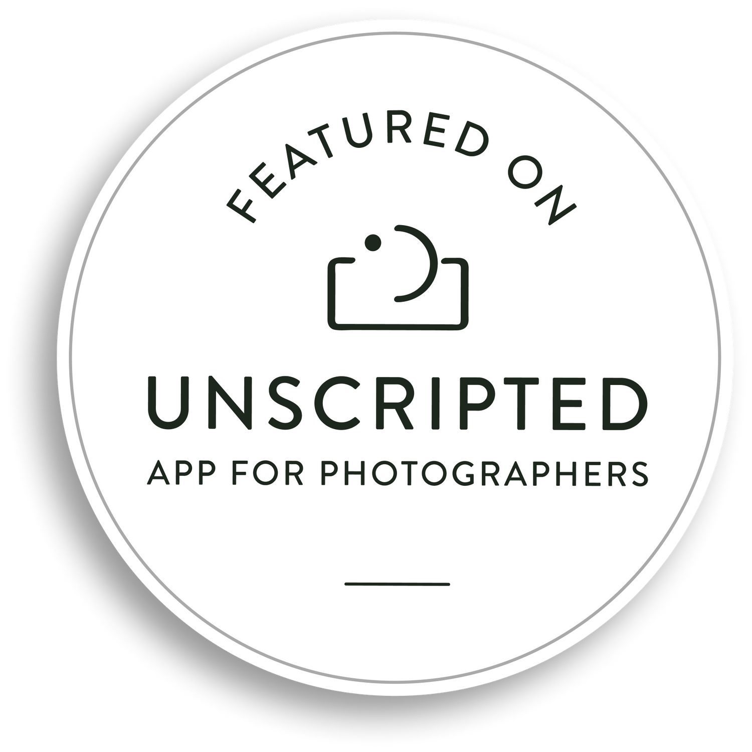 Circular black and white badge for Unscripted photography app featuring camera icon.