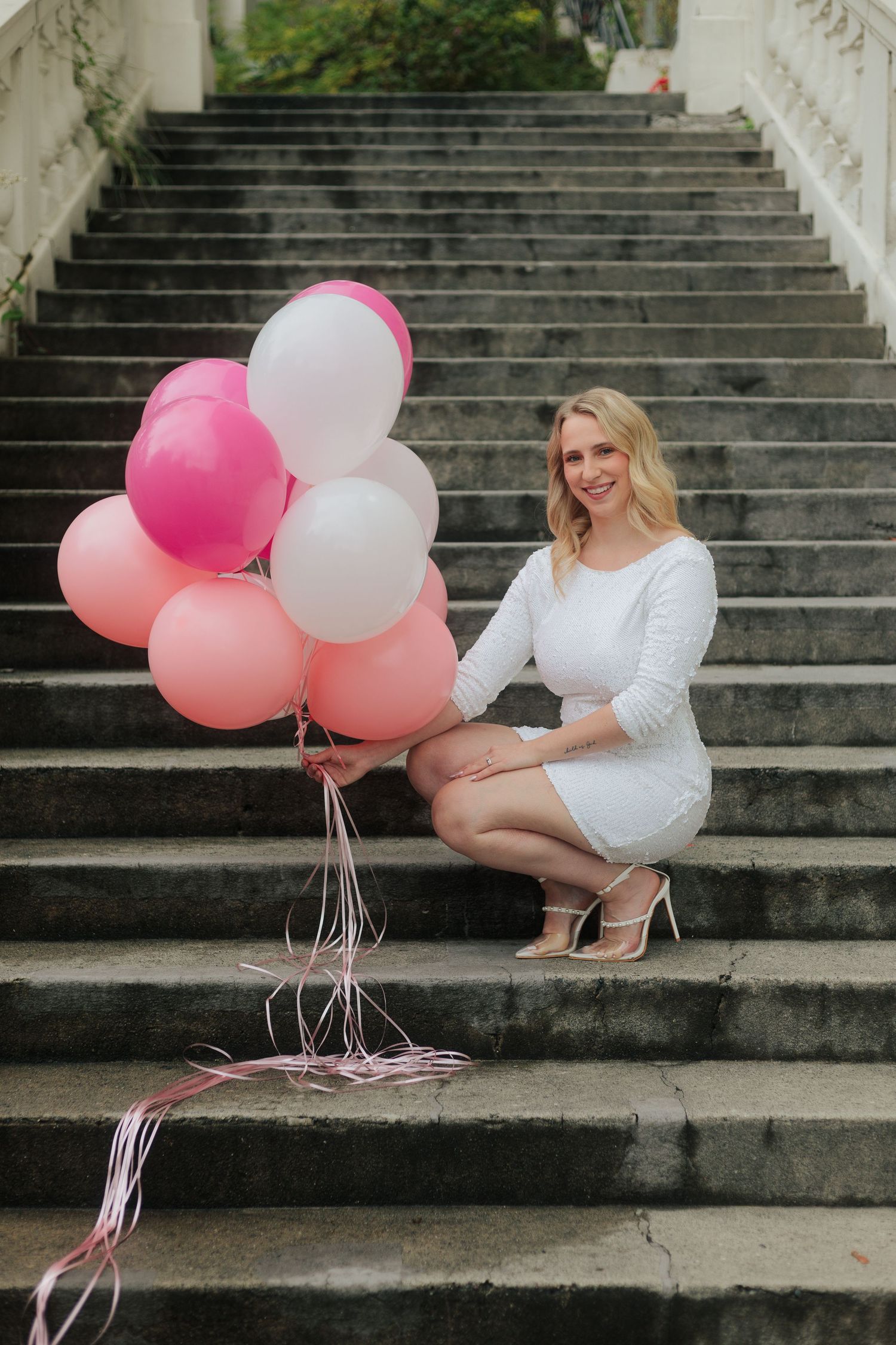 Elegant outdoor portrait session with balloons on historic stone steps.