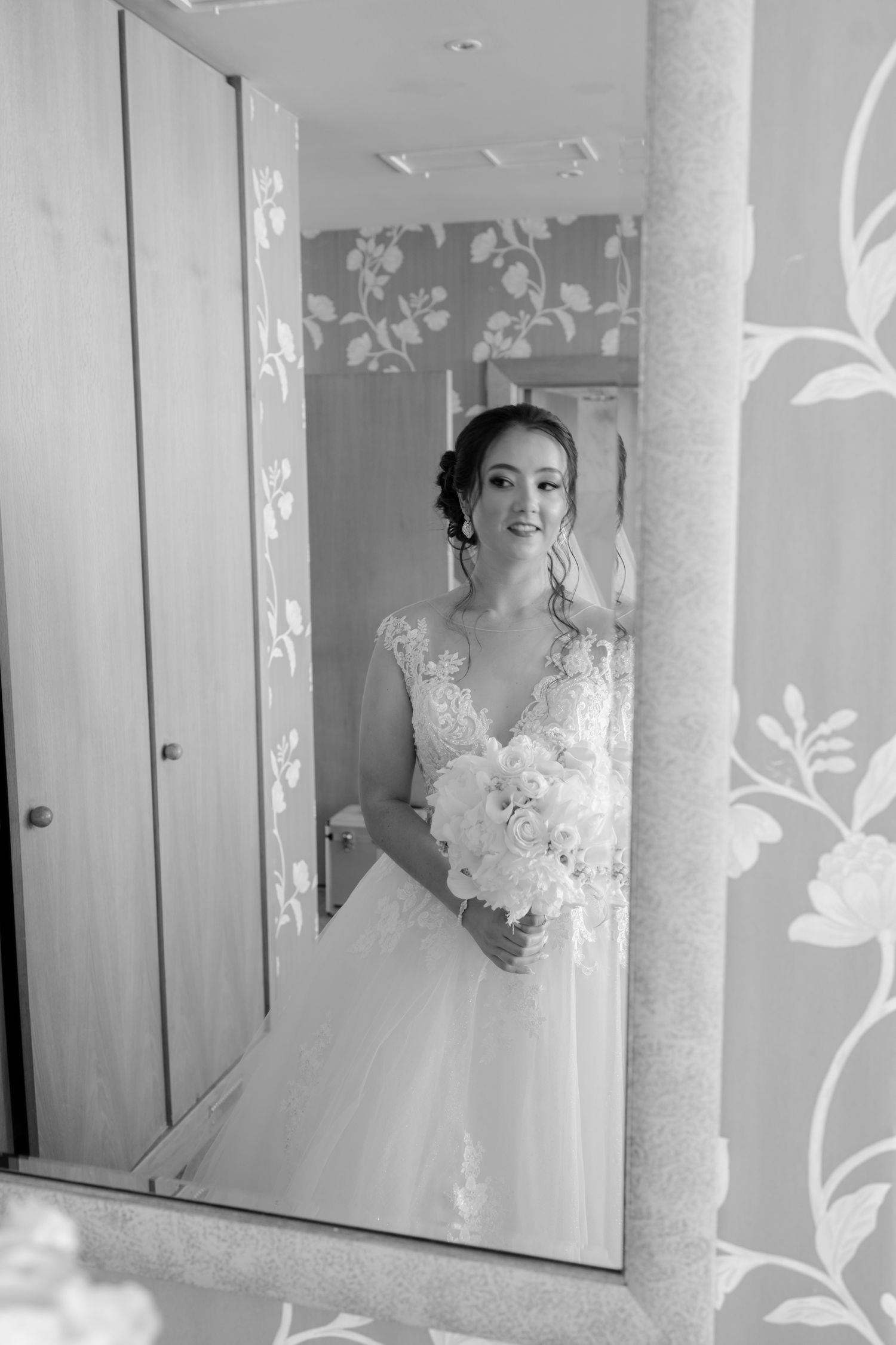 Noiva no dia do seu casamento a segurar um boquet reflectida no espelho. foto a preto e branco tirada na Quinta de Santo Andre