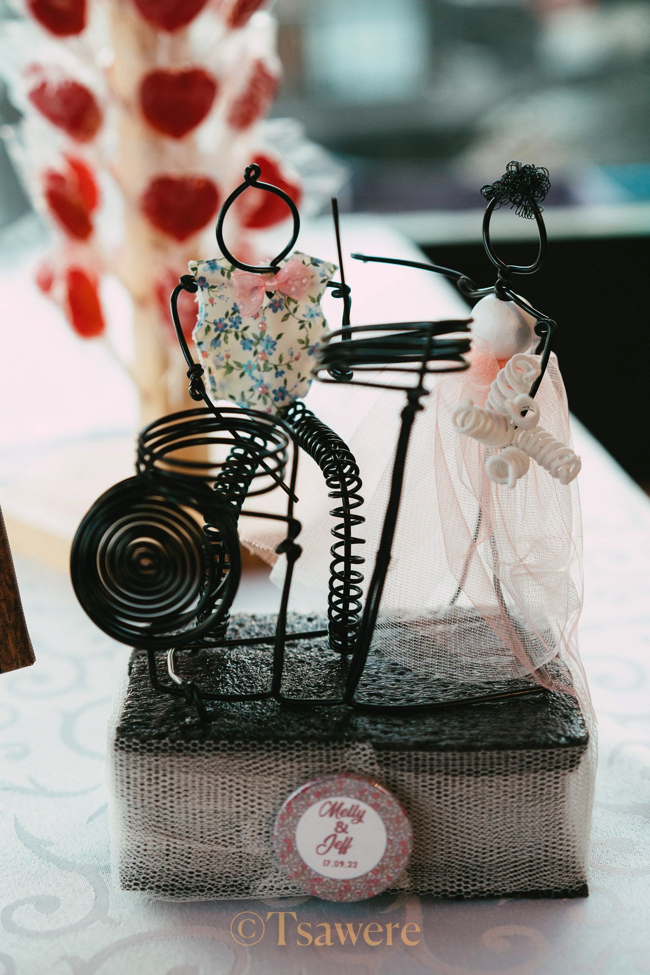 Wire art sculpture of a bride and groom on a decorative base, wedding keepsake centerpiece.