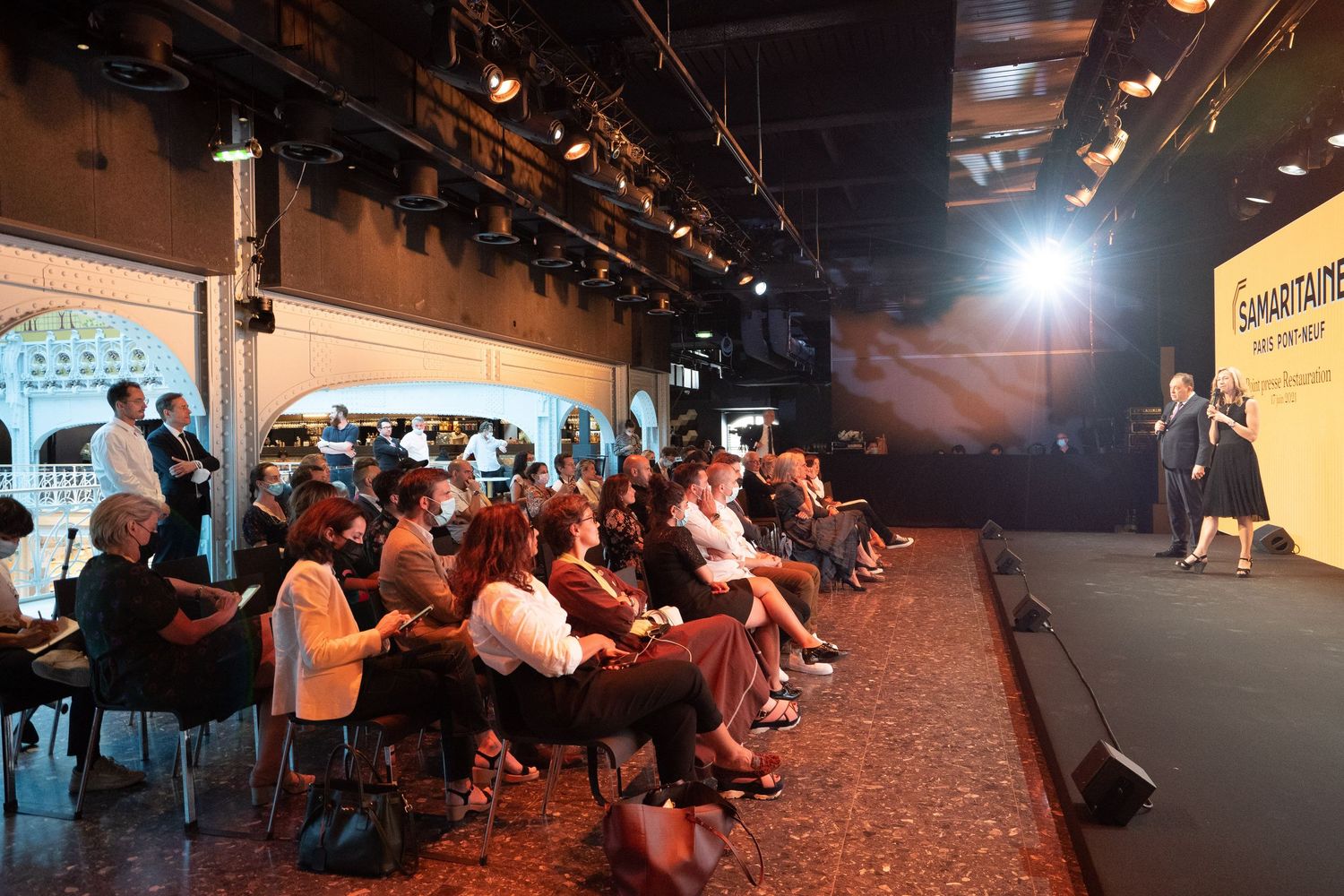 Audience seated at a presentation event with Samaritaine branding on a large screen.