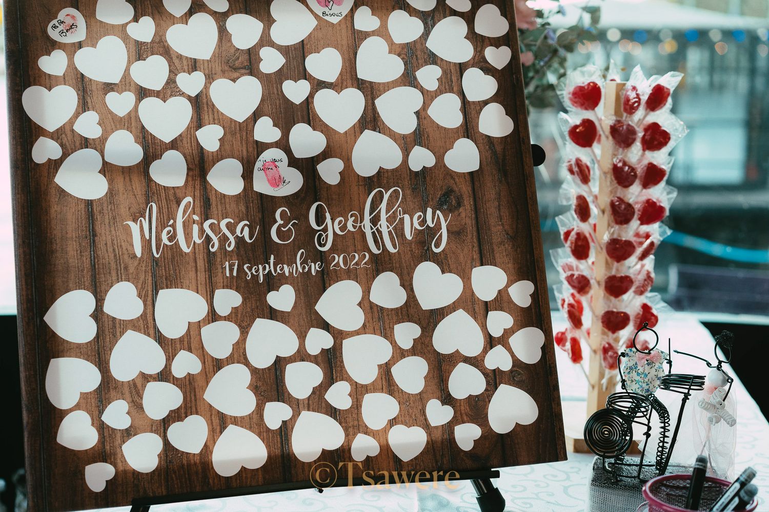 Rustic wooden wedding guest book sign with hearts reading Melissa and Geoffrey, 17 September 2022.
