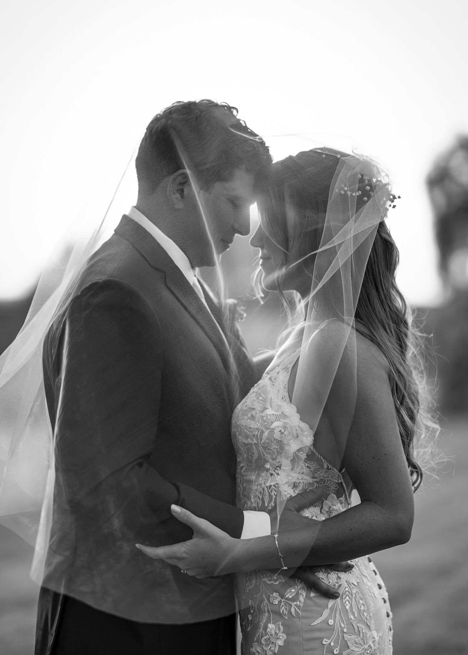 A romantic black and white wedding photo series showing three intimate moments between a couple in formal attire.