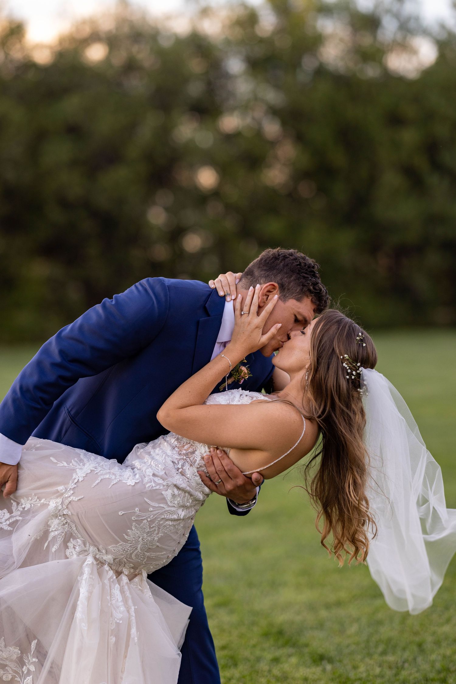 A romantic wedding couple dips and kisses on a grassy lawn at sunset in a series of progressive photos.