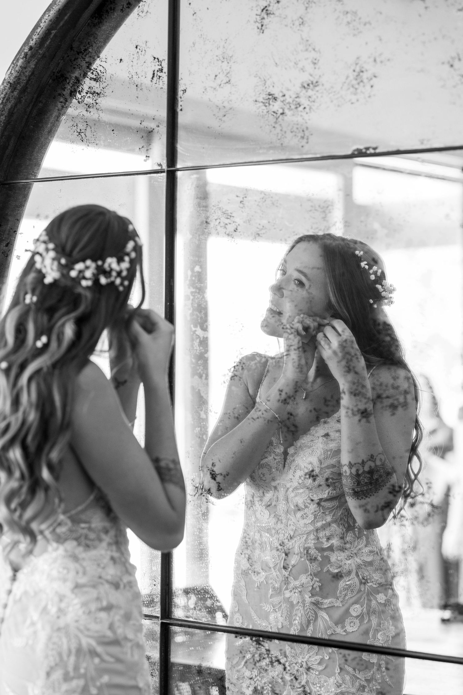 A sequence of black and white photos showing a bride getting emotional while getting ready for her wedding ceremony.