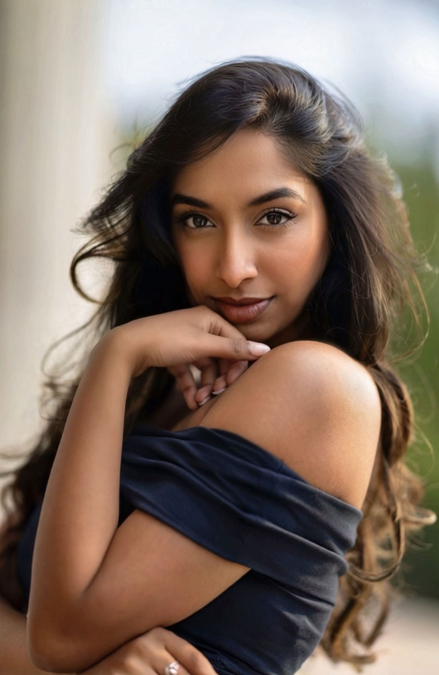 A series of glamour portraits showing a woman in a black top posing expressively against a blurred background.