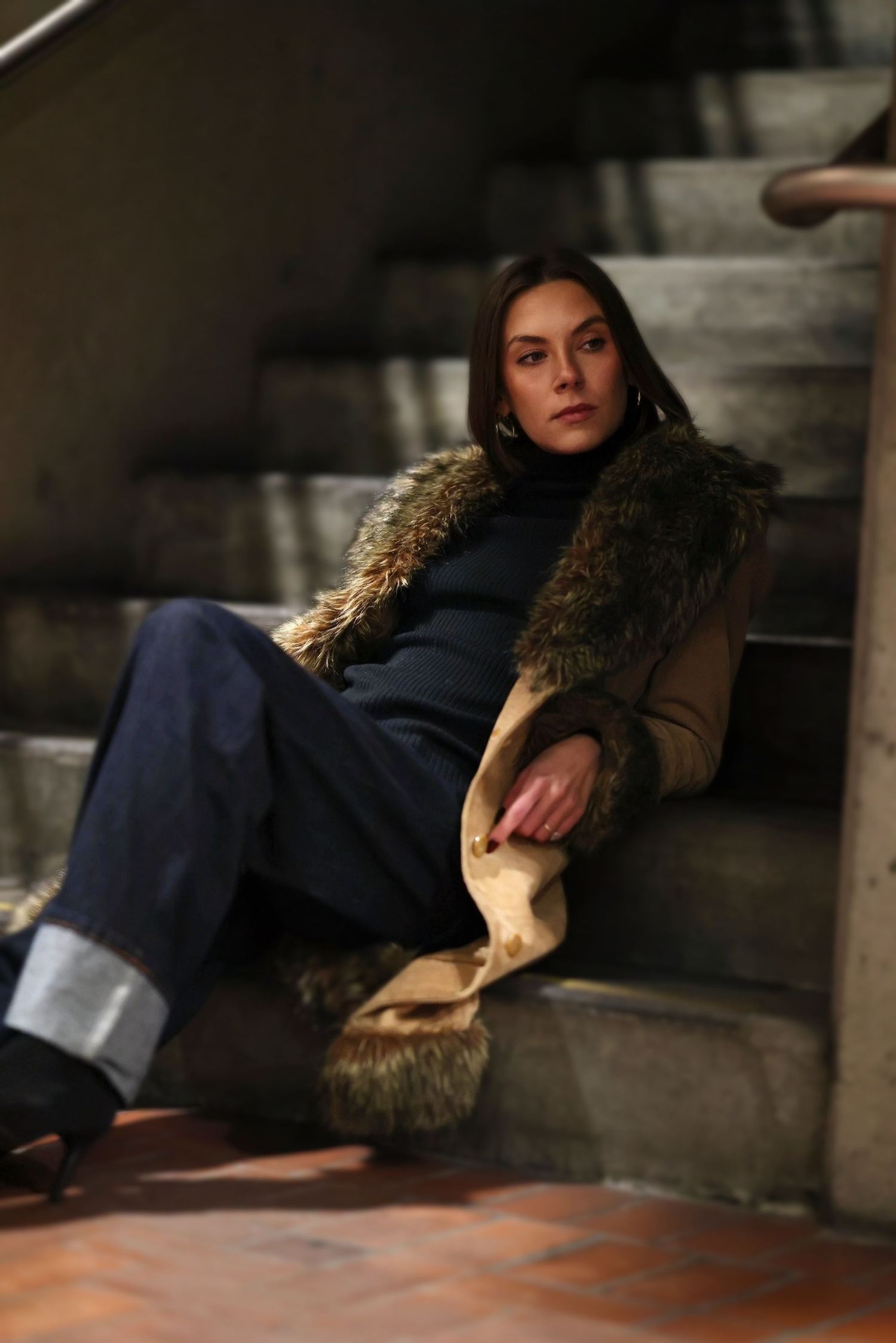 Figure lounging on concrete steps photographed from different angles in dim lighting.