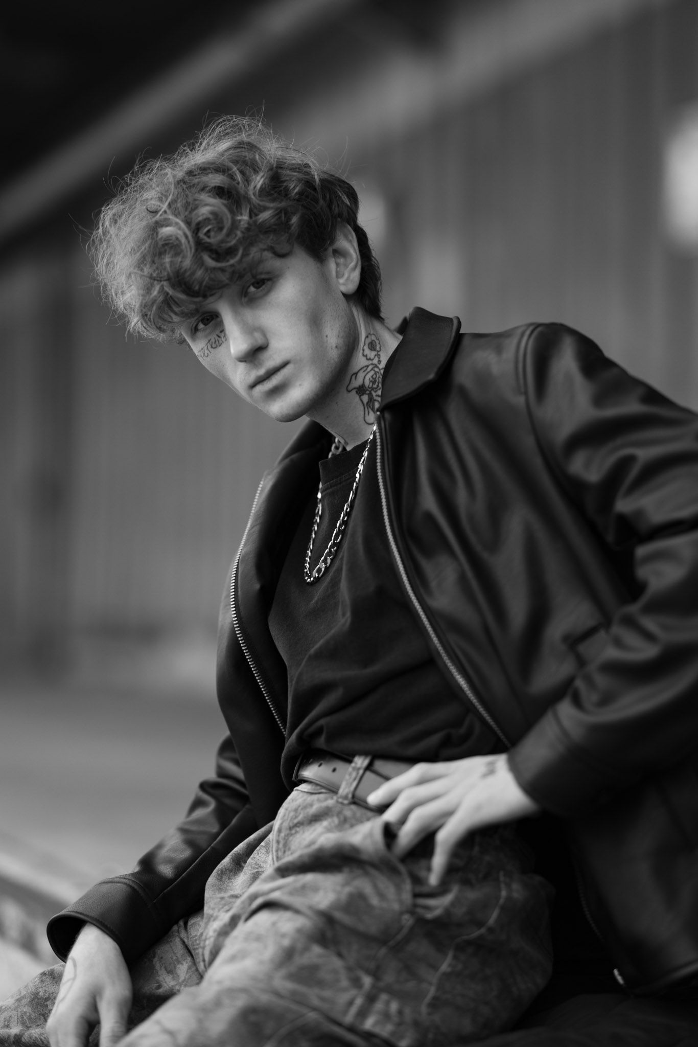A black and white photo series shows someone in a dark jacket looking downward in various contemplative poses.