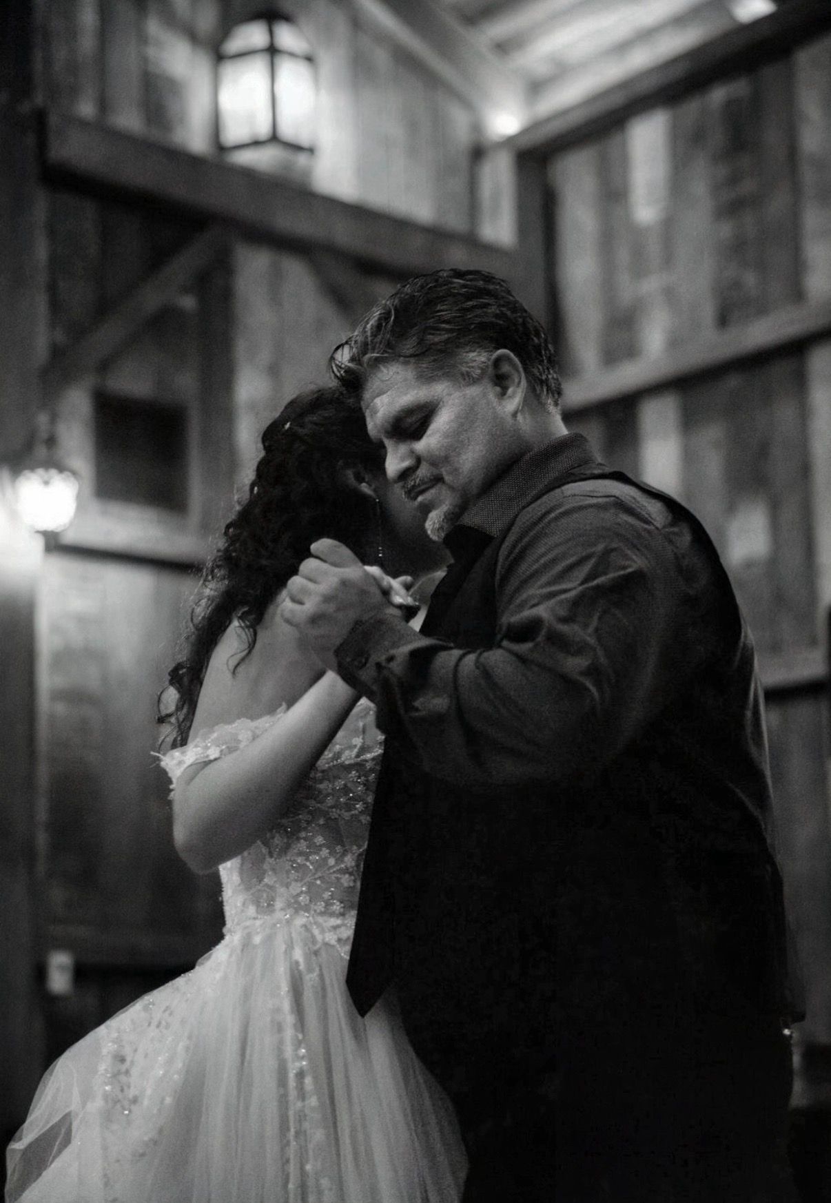 A romantic black and white wedding photo sequence showing an intimate dance between a couple in formal attire.