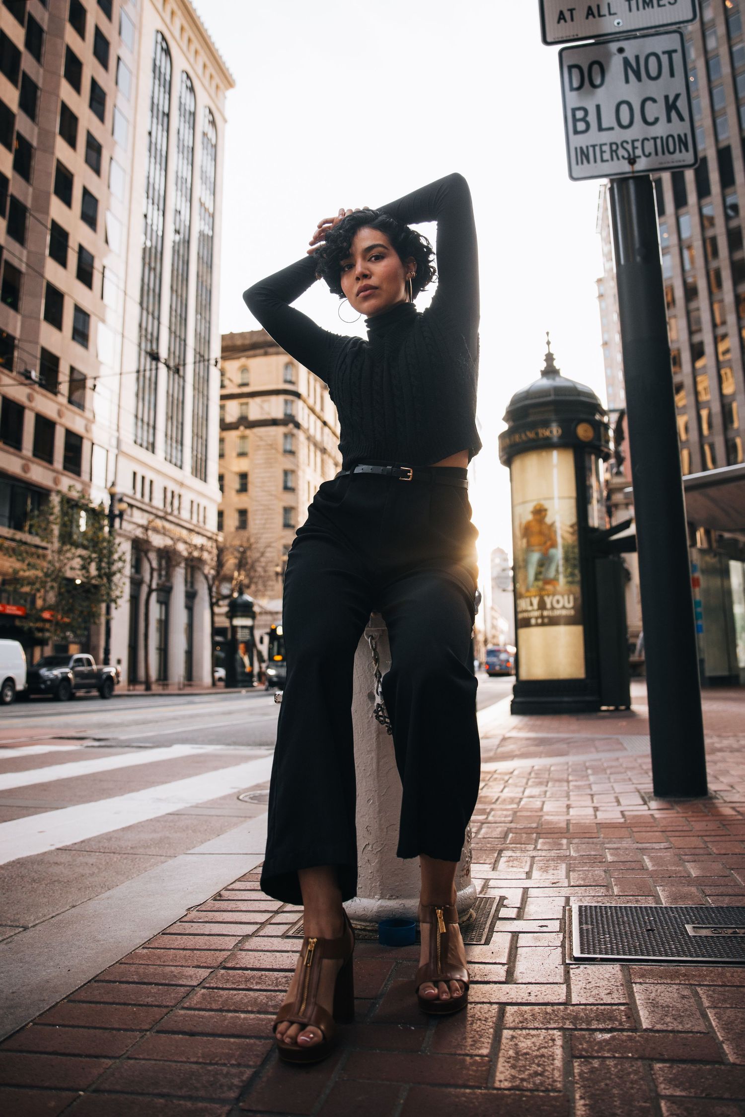 A series of street photos showing someone in dark clothing leaning against urban buildings and lamp posts.