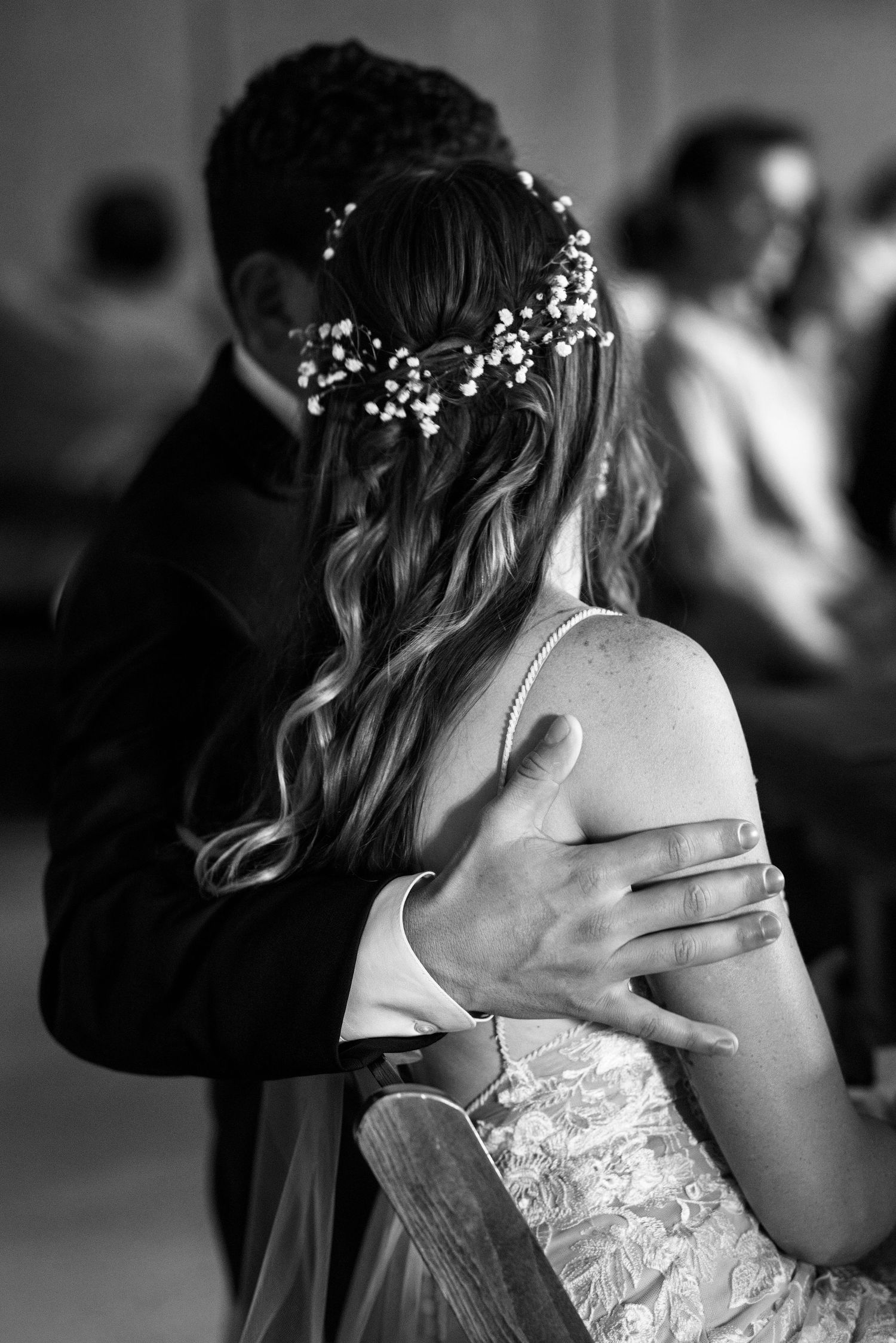 Black and white close-up photos capture tender dance moments at a wedding reception with floral details.