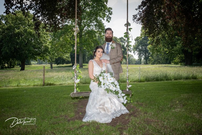 Romantic wedding portraits taken in lush garden setting with natural greenery.