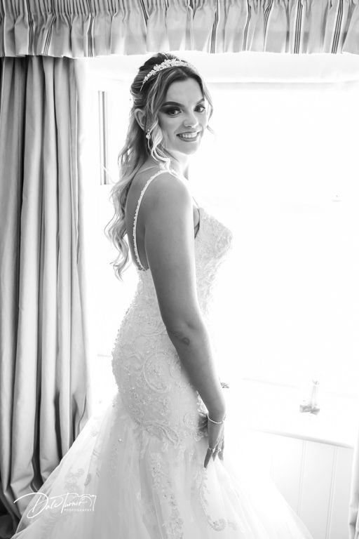 Soft, romantic bridal portraits captured through sheer curtains in natural window light.