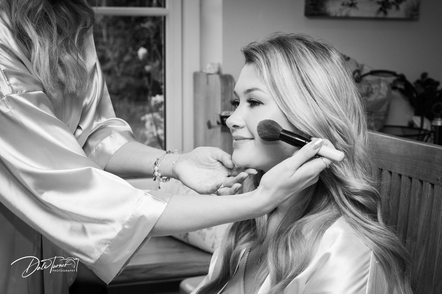 Preparation moments captured in soft black and white photography.