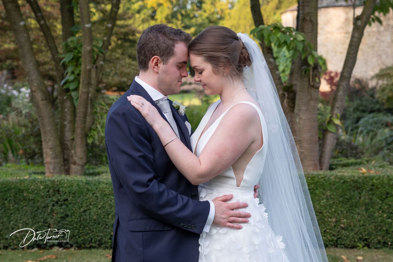 Romantic wedding photos captured in a lush garden setting with beautiful natural lighting and greenery.