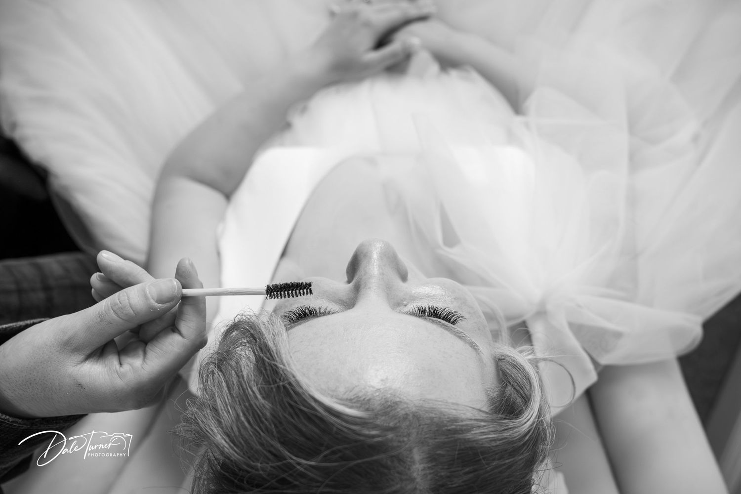 A series of black and white close-up photos showing intimate moments between a couple on their wedding day.