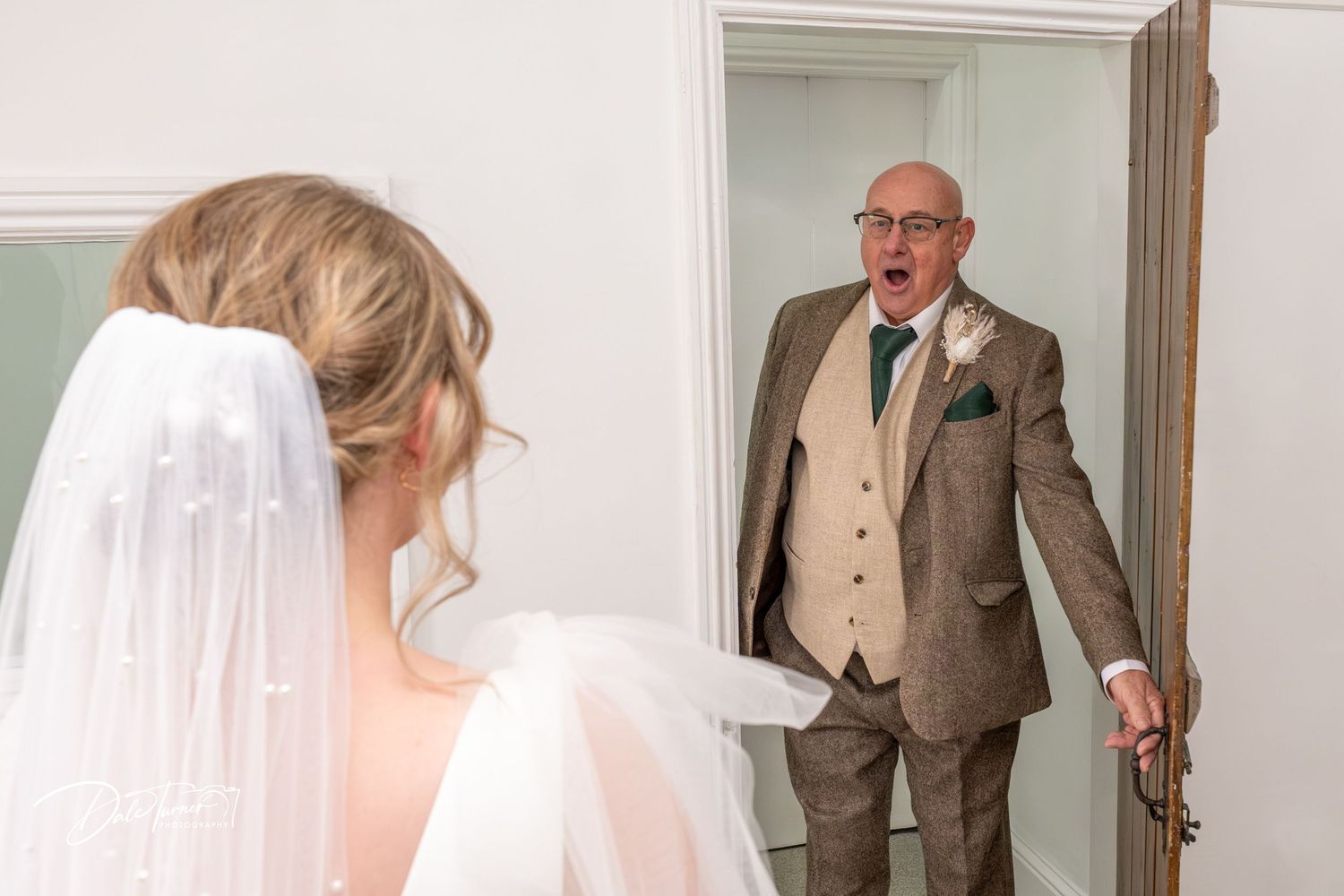 A series of emotional first look photos between a bride and father on her wedding day.