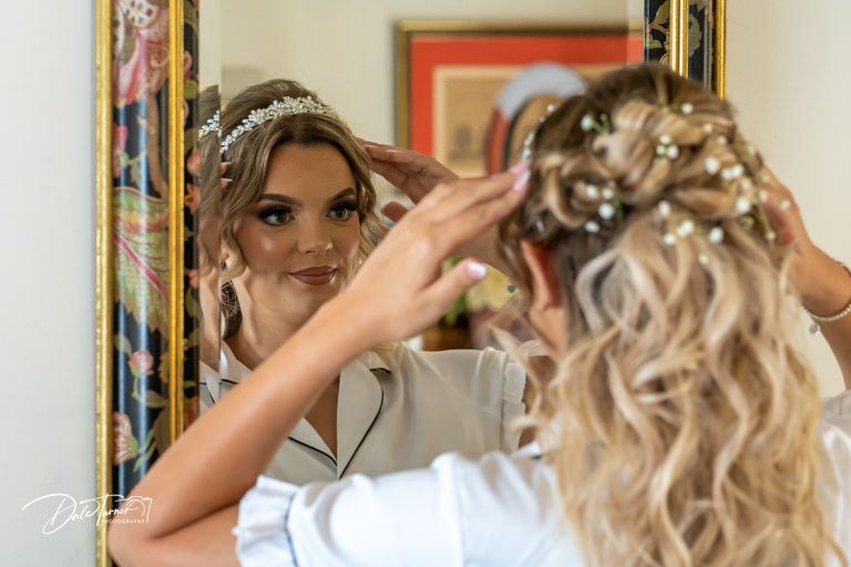 Wedding day preparation scene with elegant hairstyling and accessories.