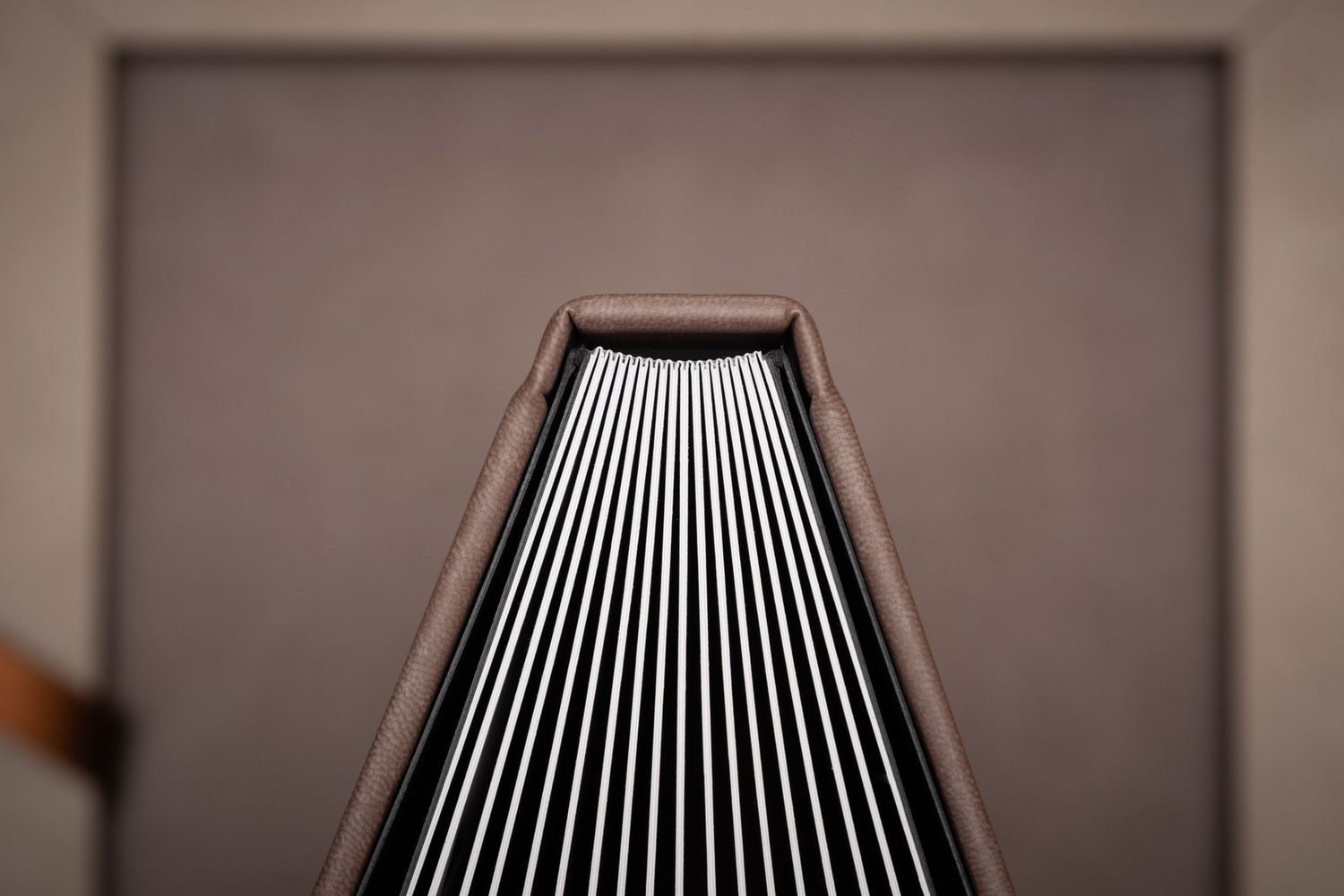 Abstract view of layered wedding album pages creating geometric patterns.