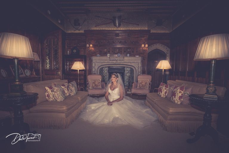 Dramatic wedding venue interior with soft lamp lighting and luxurious furnishings.