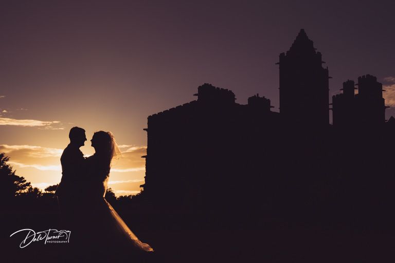 Dramatic sunset silhouette of city skyline during evening wedding photography.