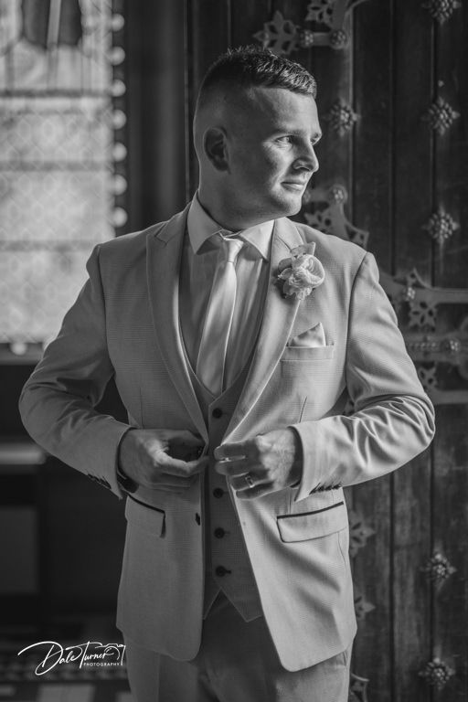 Black and white portrait shots showing details of groom in light colored formal suit.