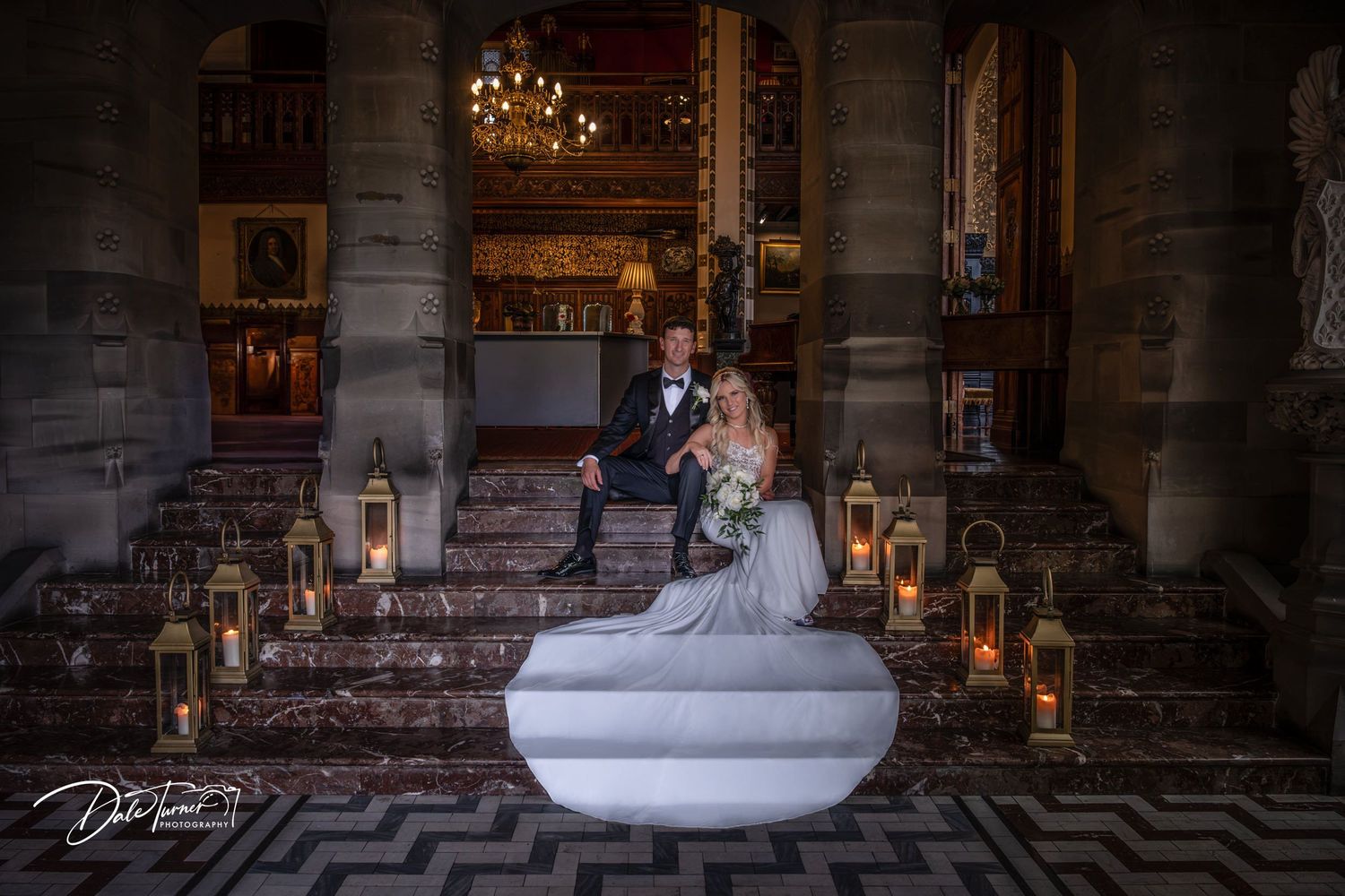 Dramatic stone archway entrance with romantic candlelit atmosphere and geometric floor pattern.