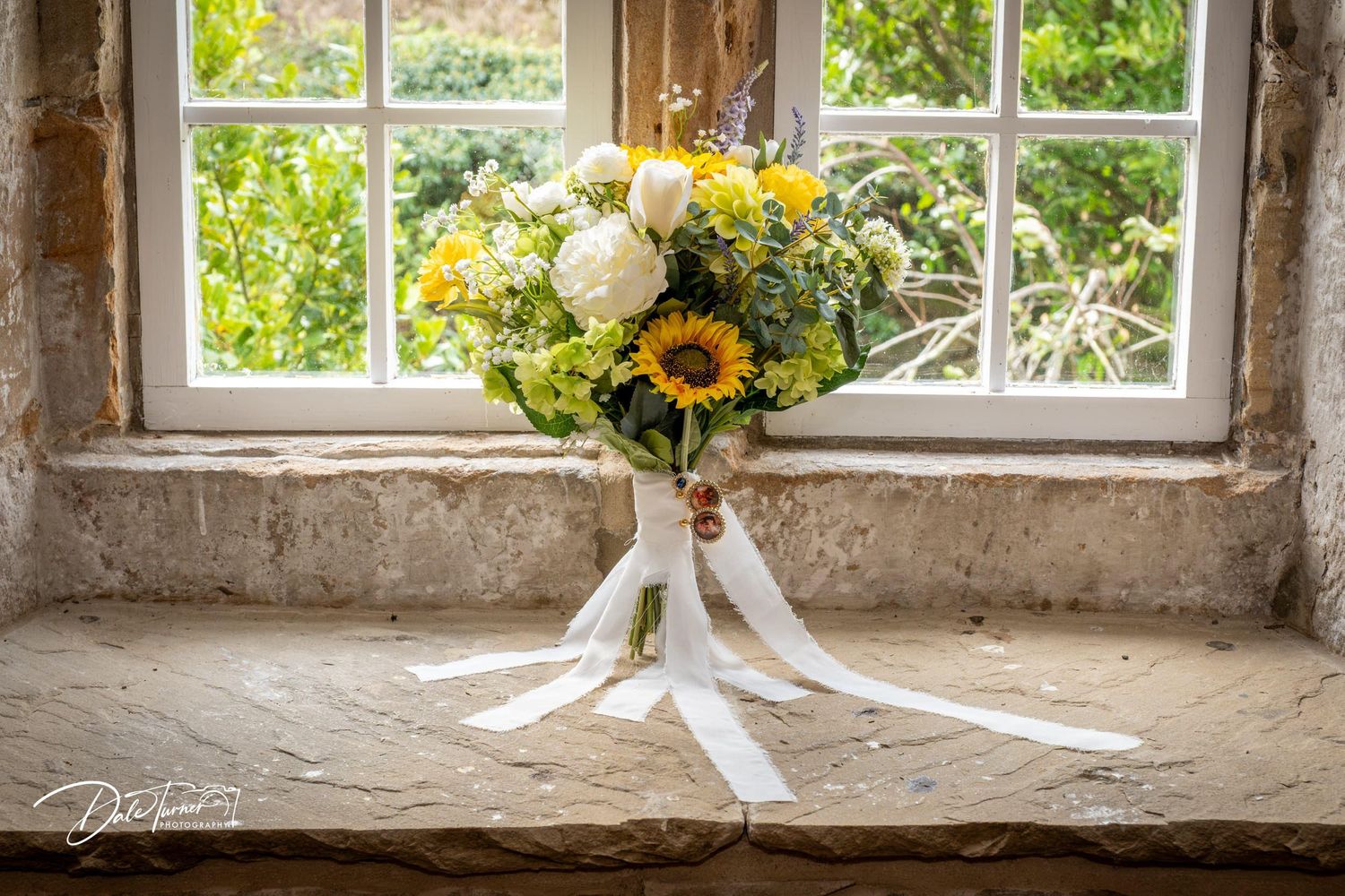Sunflowers in rustic window sills create a charming vintage display with natural light streaming through panes.