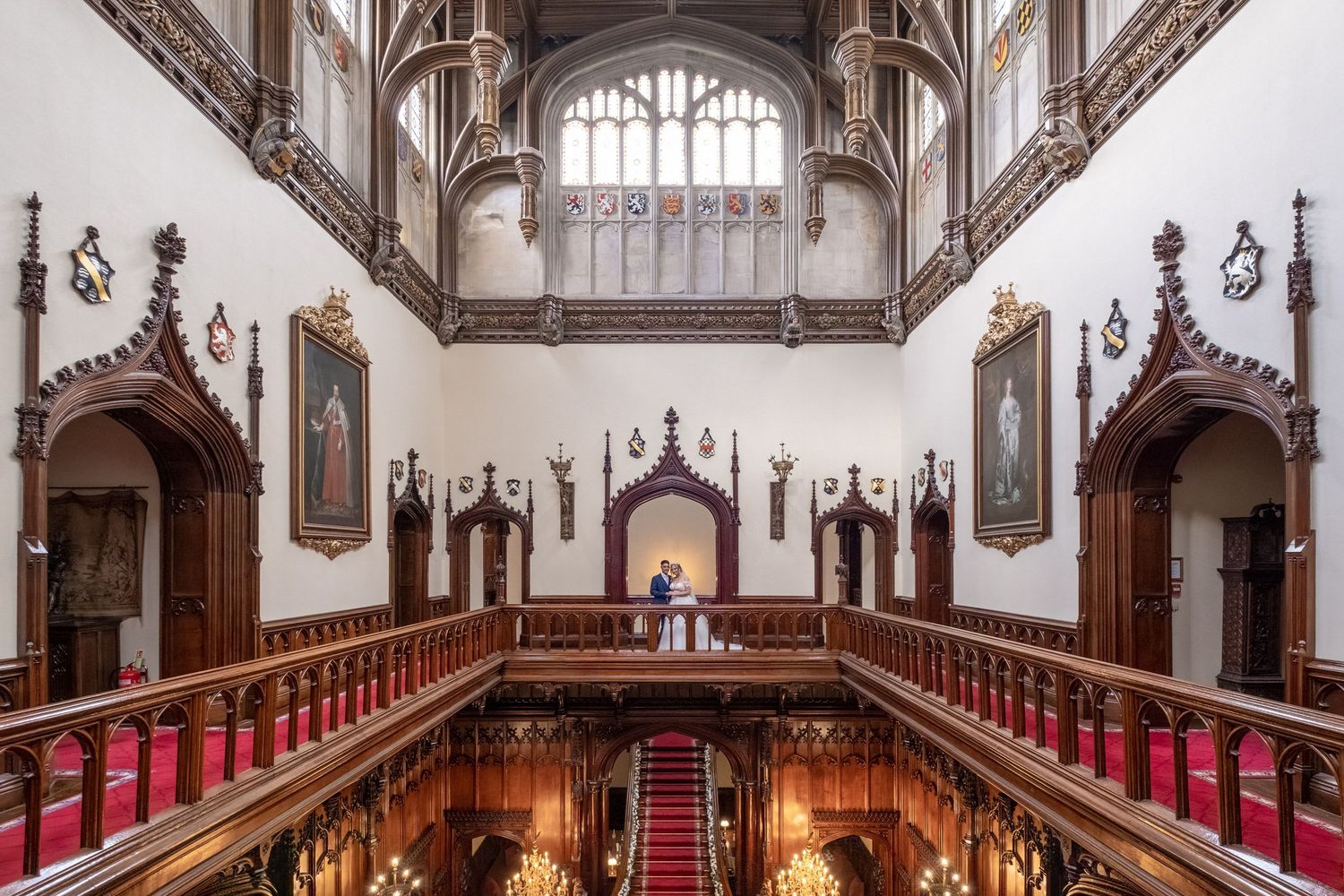 Historic chapel interior with wooden pews, vaulted ceiling, and ornate Gothic architectural details.