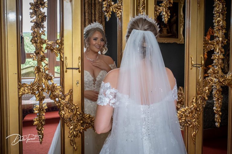 Wedding preparation scene with floral decorations and golden accents.