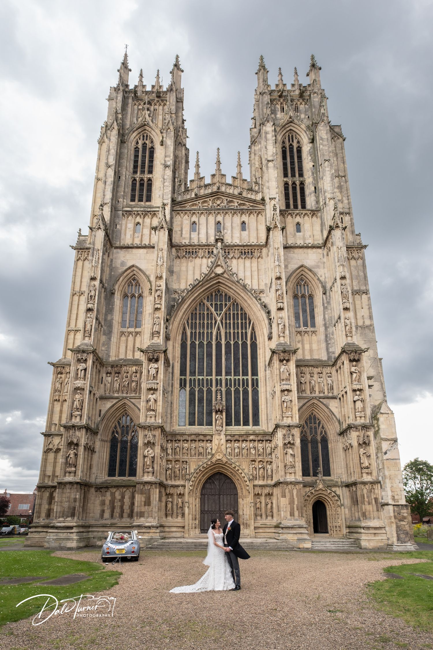 Majestic York Minster cathedral provides dramatic backdrop for wedding photographs.