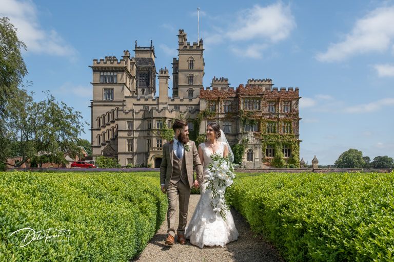 Elegant castle wedding venue with manicured grounds and stone architecture.
