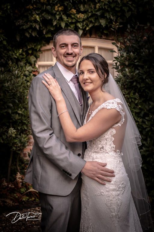 Intimate wedding portraits showing tender moments between couple in garden setting.
