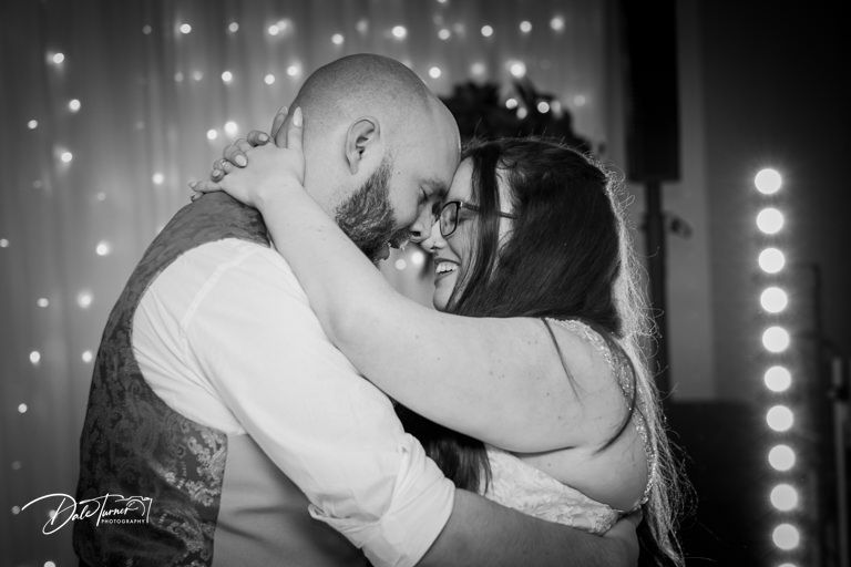 Black and white romantic dance floor moments captured during wedding reception.