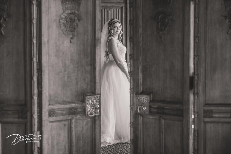 Elegant hallway with ornate wooden paneling and classic architectural details in a historic venue.