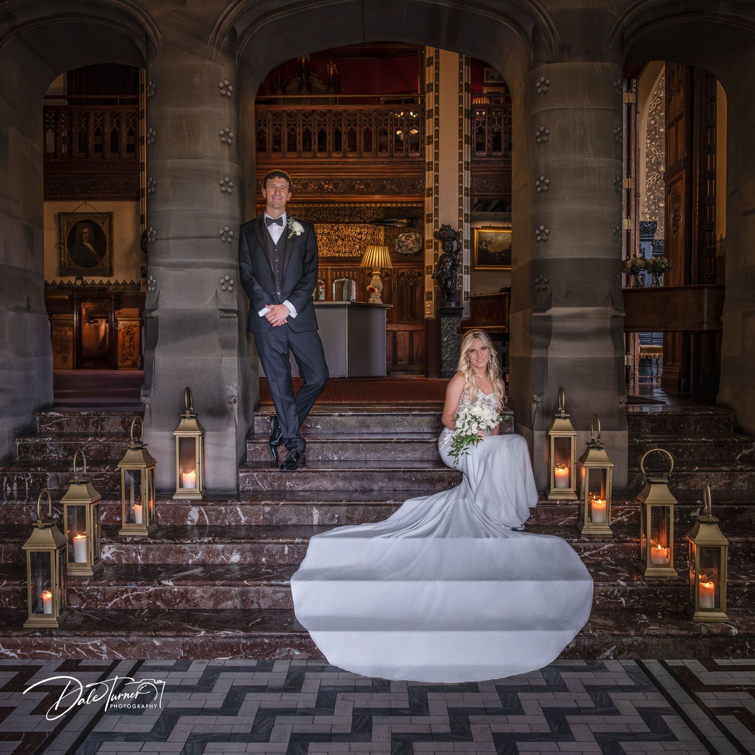 Stone colonnade with checkered floor and lanterns creating a dramatic architectural setting.