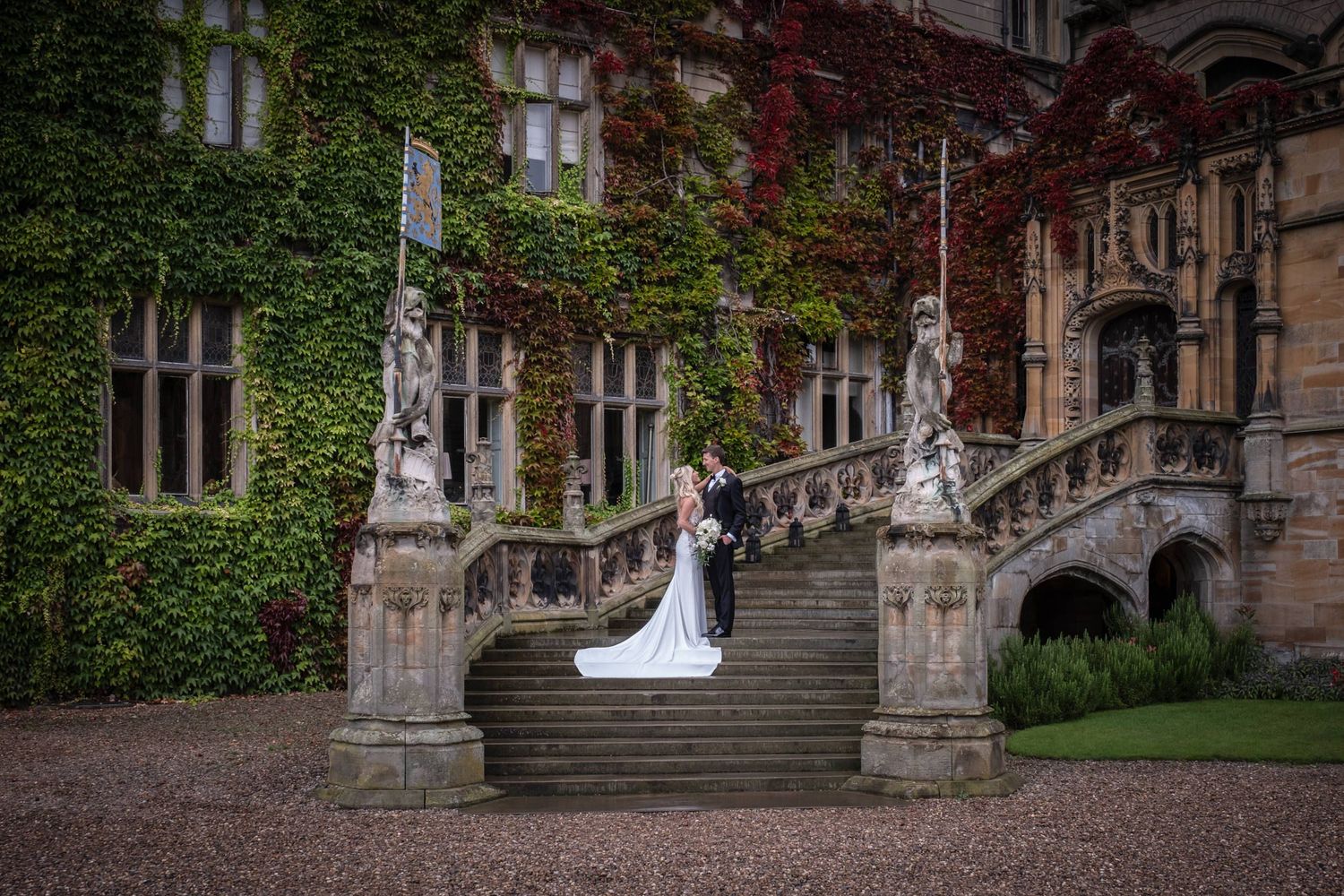 Historic stone building covered in green ivy vines creates romantic wedding photography backdrop.