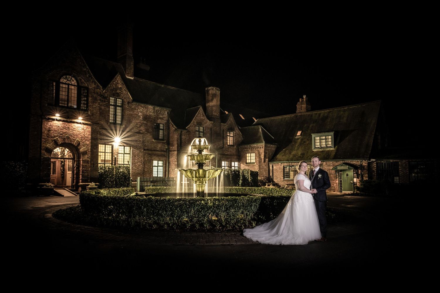 Nighttime exterior of illuminated venue with romantic lighting and architecture.