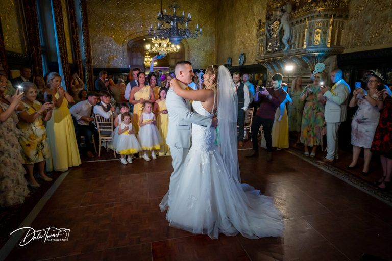 Wedding reception dance floor filled with guests celebrating at an elegant indoor venue.